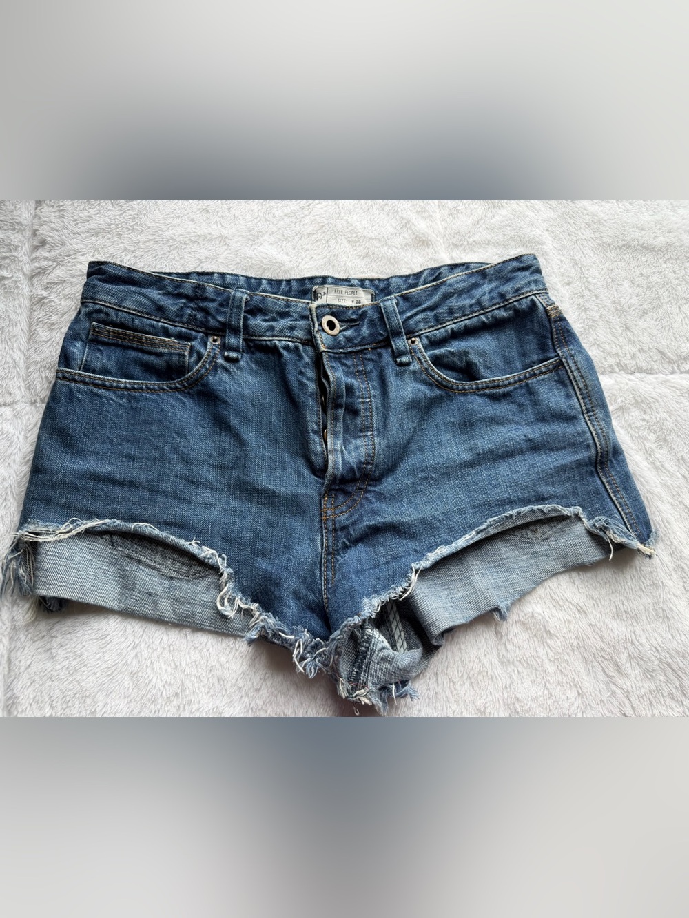 Free People medium blue distressed denim cutoff shorts